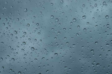 Raindrops on the window close up. rain drops on the glass macro. water drops falling down on window. rainy day