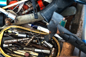 Drawer with messy tools seen from above