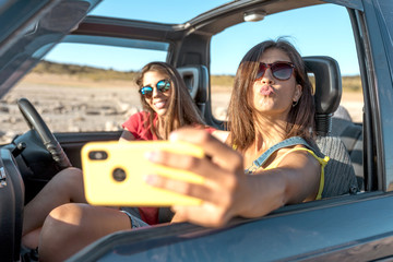 beautiful girls and young people traveling with the jeep car - 281544083