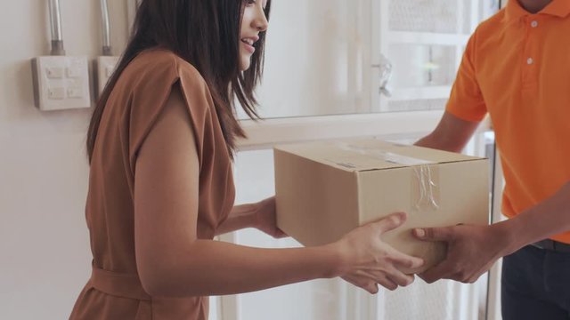 Male employee send parcels to Asian women customers at home.