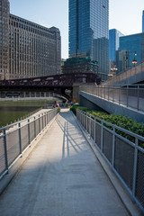 Obraz na płótnie Canvas Shadow designs from railing on ramp leading from upper Wacker Dr. to lower city along riverwalk