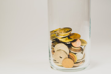 Glass jar with international coins from various countries. finance storage concept