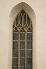 Unusual window on the facade of the old house