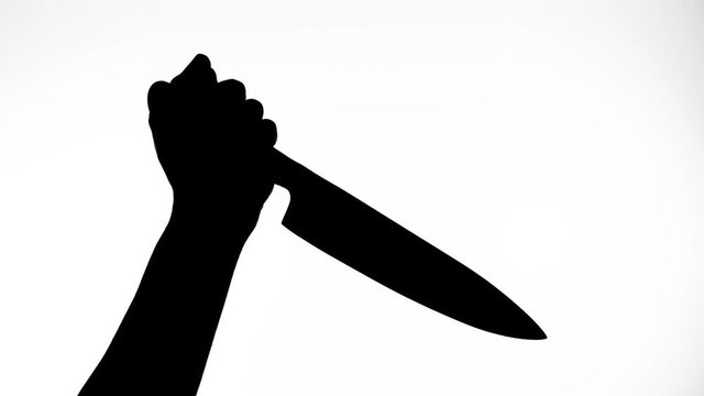 Silhouette of a hand holding a long knife threatening