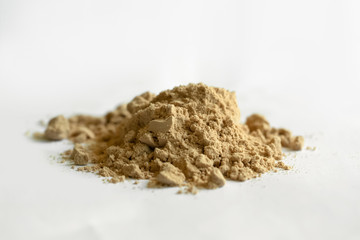 Cocoa protein powder isolated over the white background.