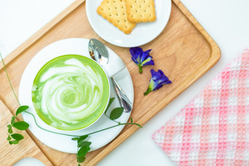 Hot green tea milk with cracker and spoon. on top