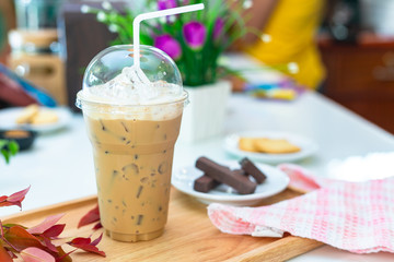 Ice coffee on a wood table with dessert refreshing look of the drink.