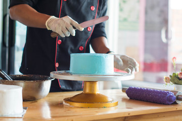 portrait Body part of pastry chef doing decorating cake process