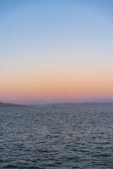 Sunset on the water with blues, purples and pink color sky