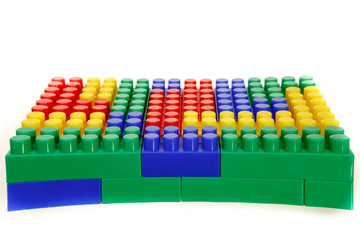 Naklejka premium Children's colorful plastic construction toy bricks on white