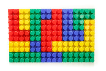 Children's colorful plastic construction toy bricks on white