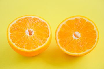orange slice on yellow background / close up of fresh Orange fruit