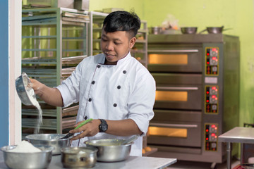 Fototapeta premium pastry chef with ingridient at kitchen