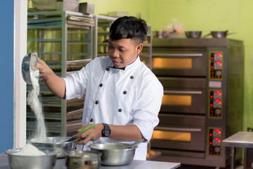 Fototapeta premium pastry chef with ingridient at kitchen