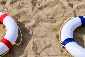 red and blue buoys on  sand with copy space