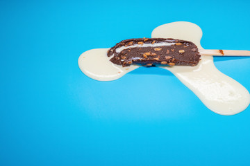 chocolate outer popsicle with beans melting on blue background
