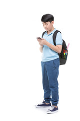 Student boy with backpack and stationery holding cell phone .