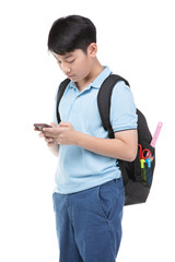 Student boy with backpack and stationery holding cell phone .