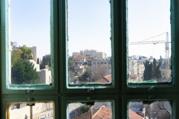 Fototapeta na wymiar Looking out of a old green window in Tel Aviv, Israel