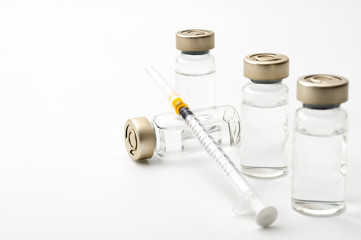 Vaccines, botulinum toxin and insulin ampules concept theme with glass vials with clear liquid next...
