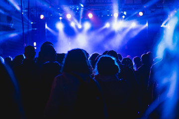 Fototapeta na wymiar Tel Aviv, Israel February 23, 2018: Blue lights at a concert with people in the foreground