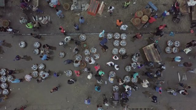 Top view of people are buying and selling fish in the traditional fish pier