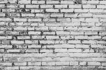 Fototapeta premium Texture of a brick wall with cracks and scratches which can be used as a background