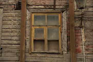 Windows of the old wooden house. wooden wall with windows