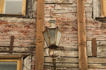 Wooden wall of old wooden house with vintage lamp