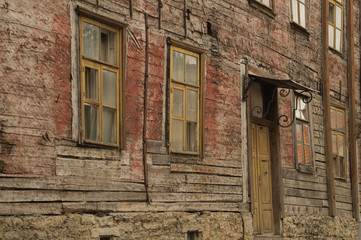 Windows of the old wooden house. wooden wall with windows and door background