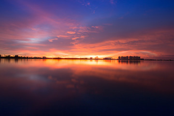 Fototapeta na wymiar Beautiful sunset with reflection sky in water