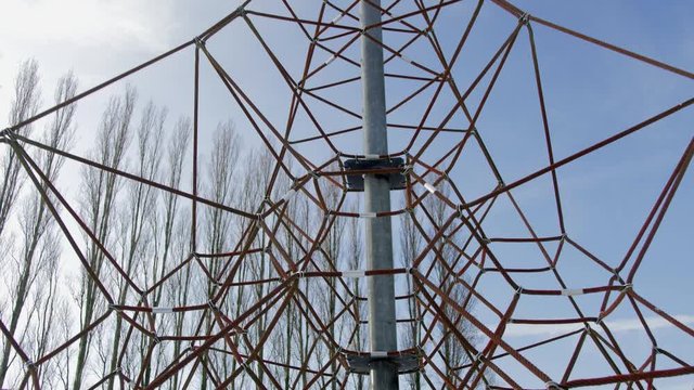 Cinematic dolly shot of an empty rope climbing net during the winter