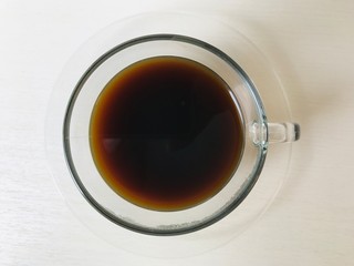 black coffee in a coffee cup top view  on white background.