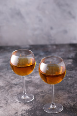 Two glasses with white wine on a textural background. Copy space. Place for your text.