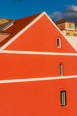 Big red house with small windows in an old town