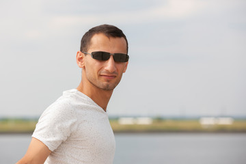 Close up of happy hipster looking at camera on a sunny day