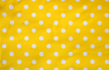 Yellow tablecloth with white dots background texture.