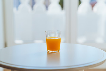 Single orange juice sitting on a table