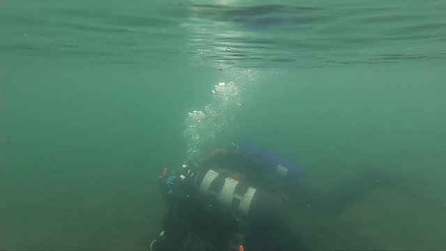 first dive in cold water, diving instructor conducting a shallow water scuba diving course in a Mountain Lake