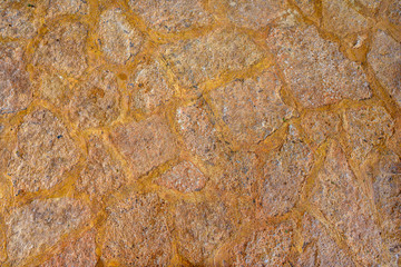 Texture stone yellow-colored clay, paving slabs yellow closeup.