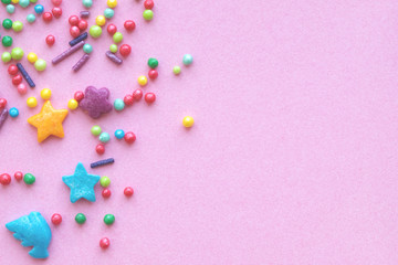 Colorful holiday background with candy on pink. Copy space for text. Greeting card for Easter,...
