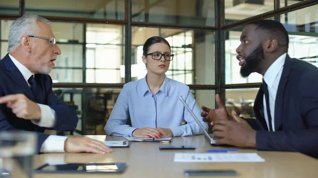 Female manager showing stop sign to arguing workers office, conflict resolution
