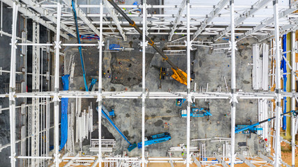 Aerial top view construction site with industrial machinery building for new  factory buildings.