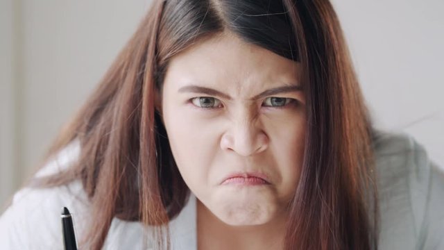 Close up of Asian women have emotion, feel angry and do strange gestures