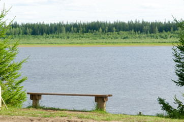 Bench for rest of tree is on the cliff North of the river Vilyui with taiga forest on the other...