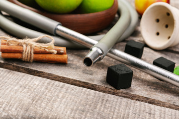 Parts of hookah and fruits on wooden background