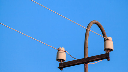 old electric pillar with glass insulators and wires