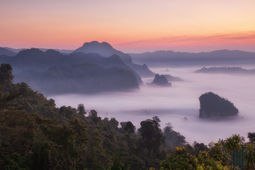 Fototapeta na wymiar Scenic mountain landscape view and fog on the hill in Phu Lung ka forest park during the sunrise, natural landmark located in Phayao province, Thailand