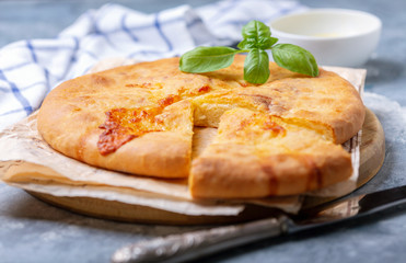 Closed cheese pie (khachapuri) close-up.