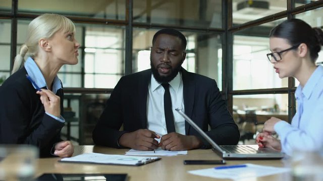 Meditating businessman in office feeling tired of shouting female conflicts
